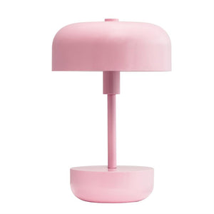 Bordlampe står lodret; har cylindrisk stang, afrundet skærm og skålformet base i ensartet lyserød; placeret mod neutral hvid baggrund.