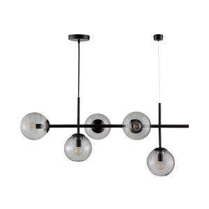Sort metal loftlampe med fem runde røgfarvede glasskærme; den hænger fra to loftbeslag i forskellige højder, glas indeholdende synlige pærer, mod en ensartet hvid baggrund.