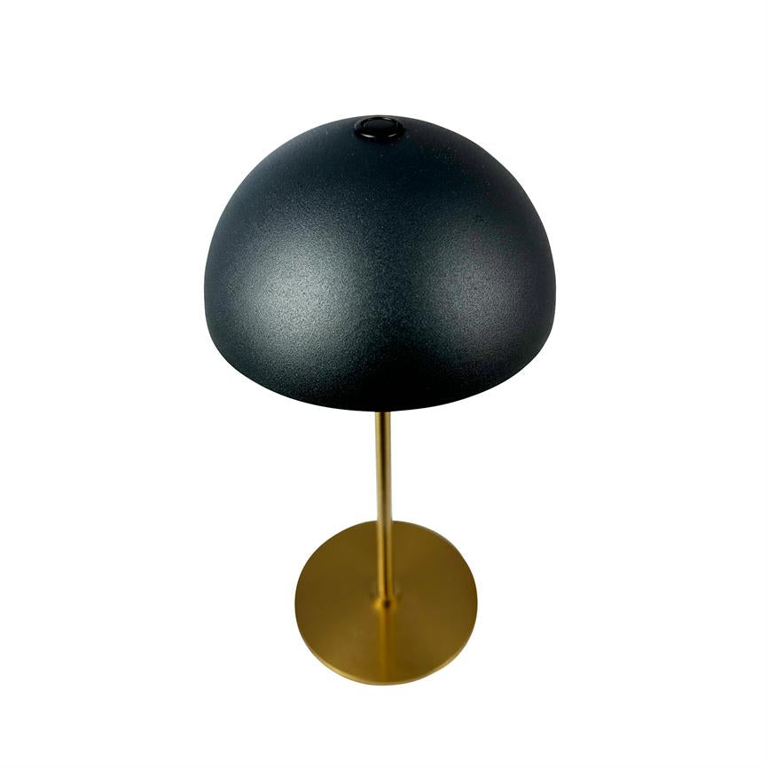 Sort halvkugleformet bordlampe står på en slank guldfarvet stang med rund fod; skærmen er mat og minimalistisk, placeret mod en ensartet hvid baggrund.