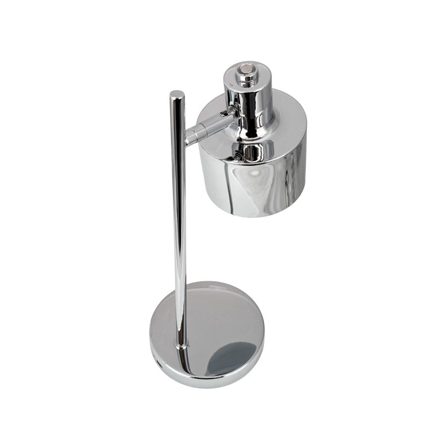 Krom bordlampe står lodret; cylinderformet skærm er monteret på en kort arm og peger ned mod en rund, reflekterende base på en hvid baggrund.
